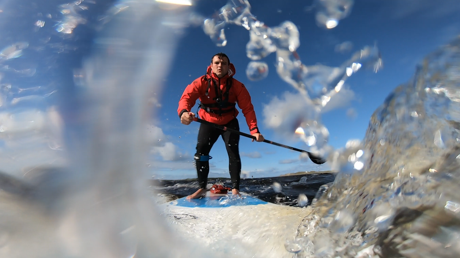 A man on a paddle board out on the water